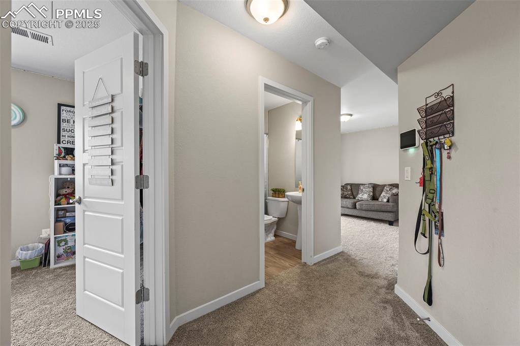 Image 27 of 44: Hall with carpet flooring and baseboards