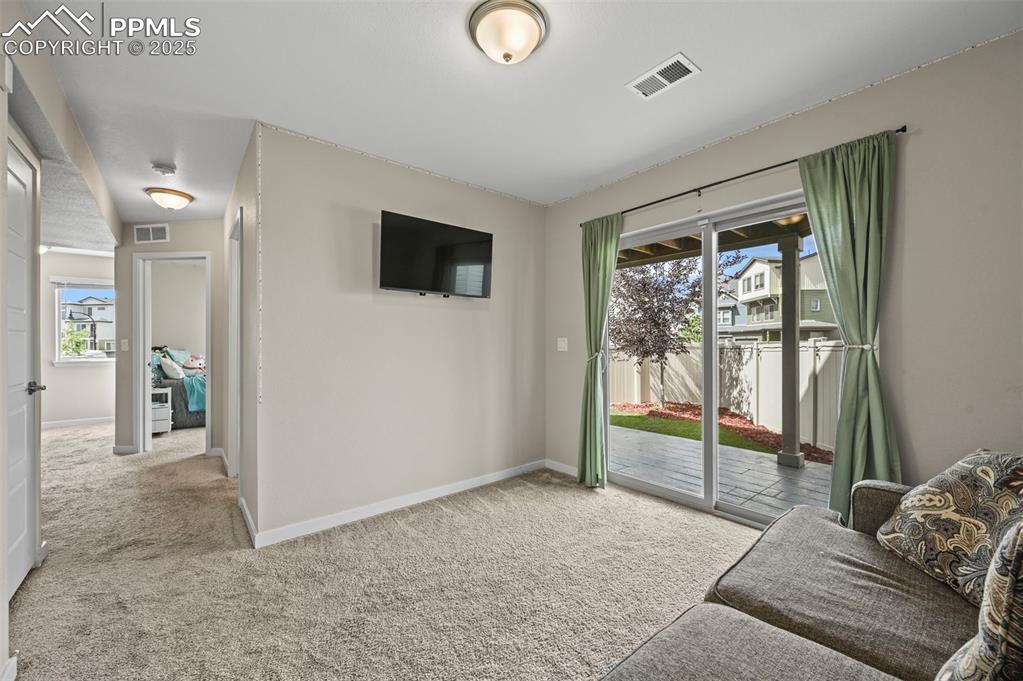 Image 29 of 44: Living area featuring carpet and baseboards