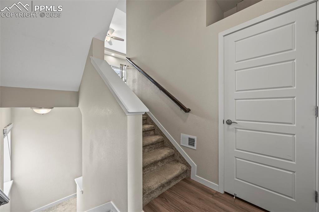 Image 3 of 44: Stairway featuring wood finished floors and a ceiling fan