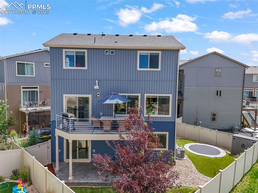 Image 39 of 44: Back of property featuring a fenced backyard and a patio