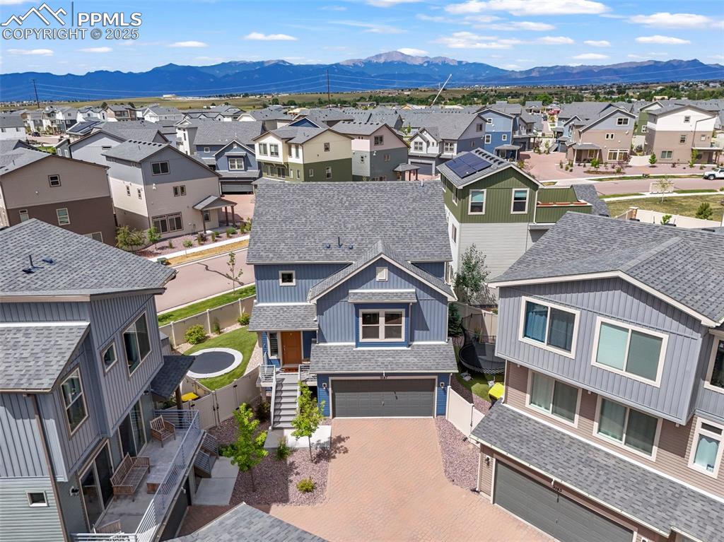 Image 40 of 44: Aerial view of residential area featuring a mountain backdrop