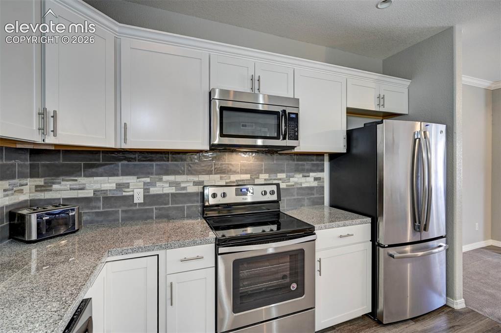 Image 8 of 40: Built in Microwave & Refrigerator w/ French Doors