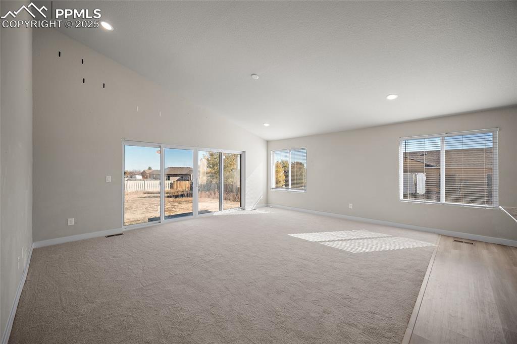 Image 10 of 30: Empty room with healthy amount of natural light, recessed lighting, light c