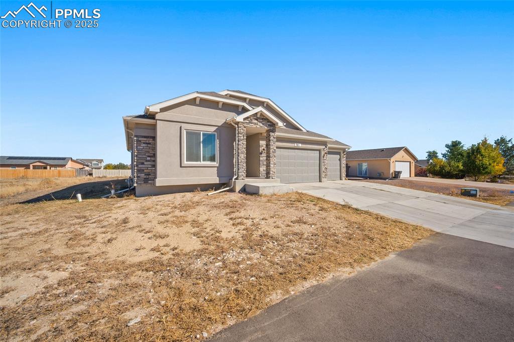 Image 2 of 30: View of front facade featuring concrete driveway, stucco siding, and an att
