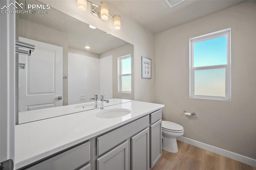 Image 21 of 30: Bathroom featuring light wood-type flooring and vanity
