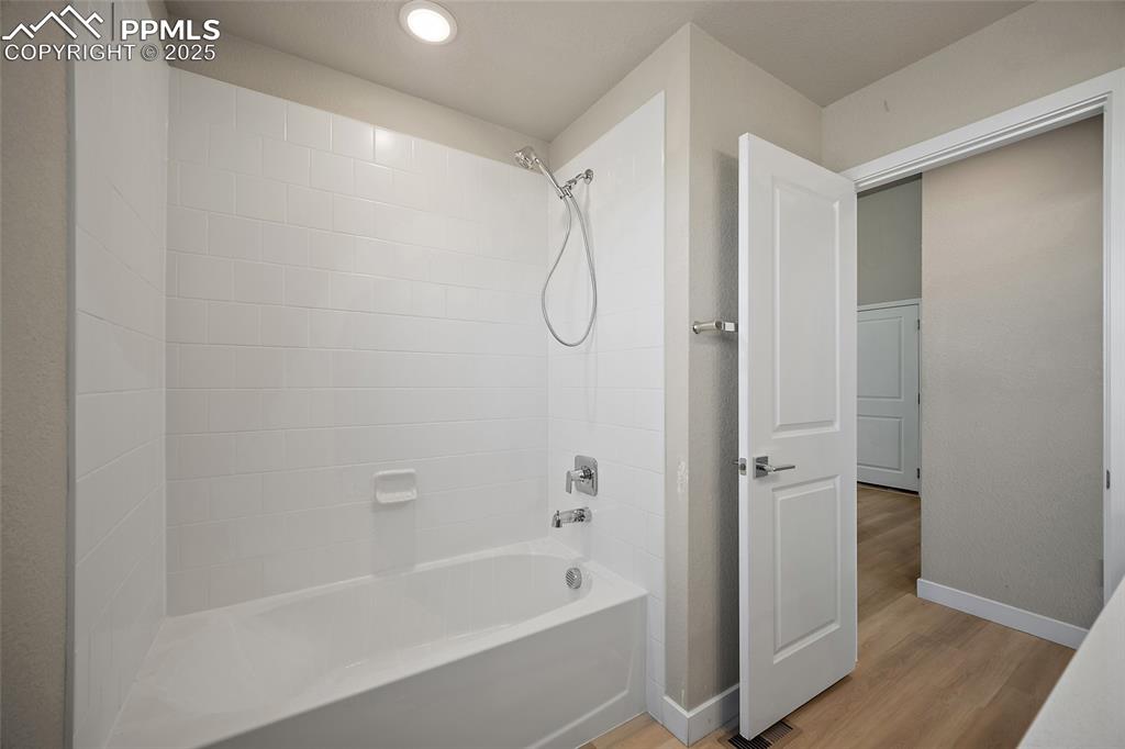 Image 22 of 30: Bathroom with shower / bath combination, light wood-style flooring, and rec