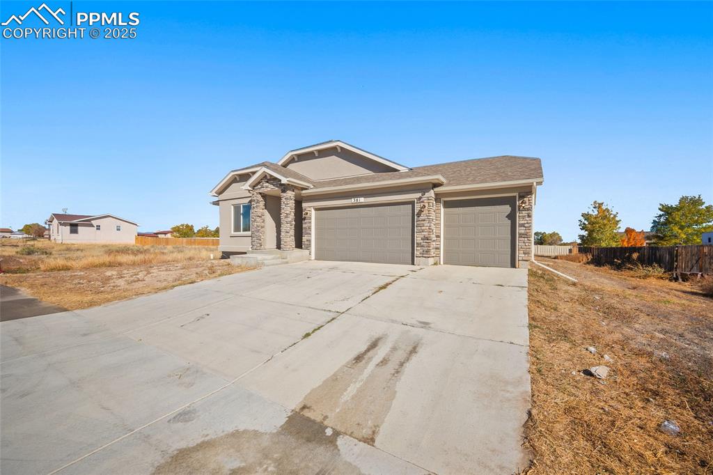 Image 3 of 30: View of front of home with driveway, an attached garage, and a shingled roo