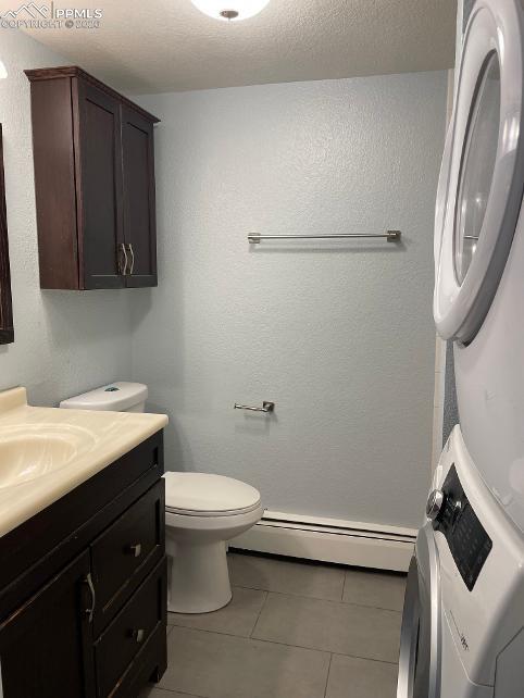 Image 12 of 28: Main-level 3/4 bath: vanity and toilet on left side, laundry area and showe