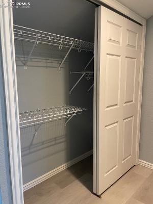Image 17 of 28: Closet in Master Bedroom with multiple shelves and rods