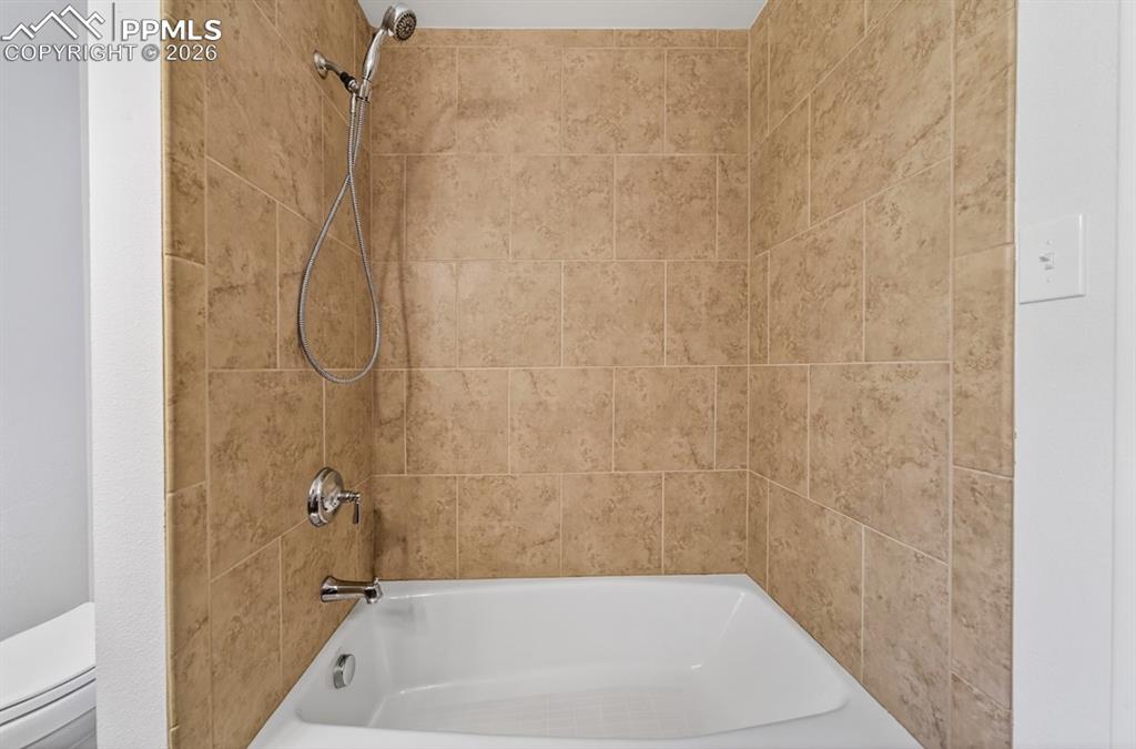 Image 30 of 46: Bathroom vanity with an integrated basin, a polished chrome faucet, and a l