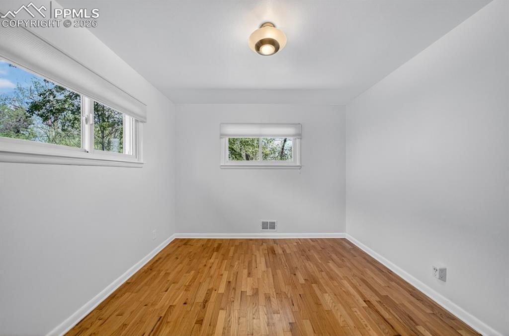 Image 33 of 46: Hardwood flooring throughout, white walls, and a recessed closet space