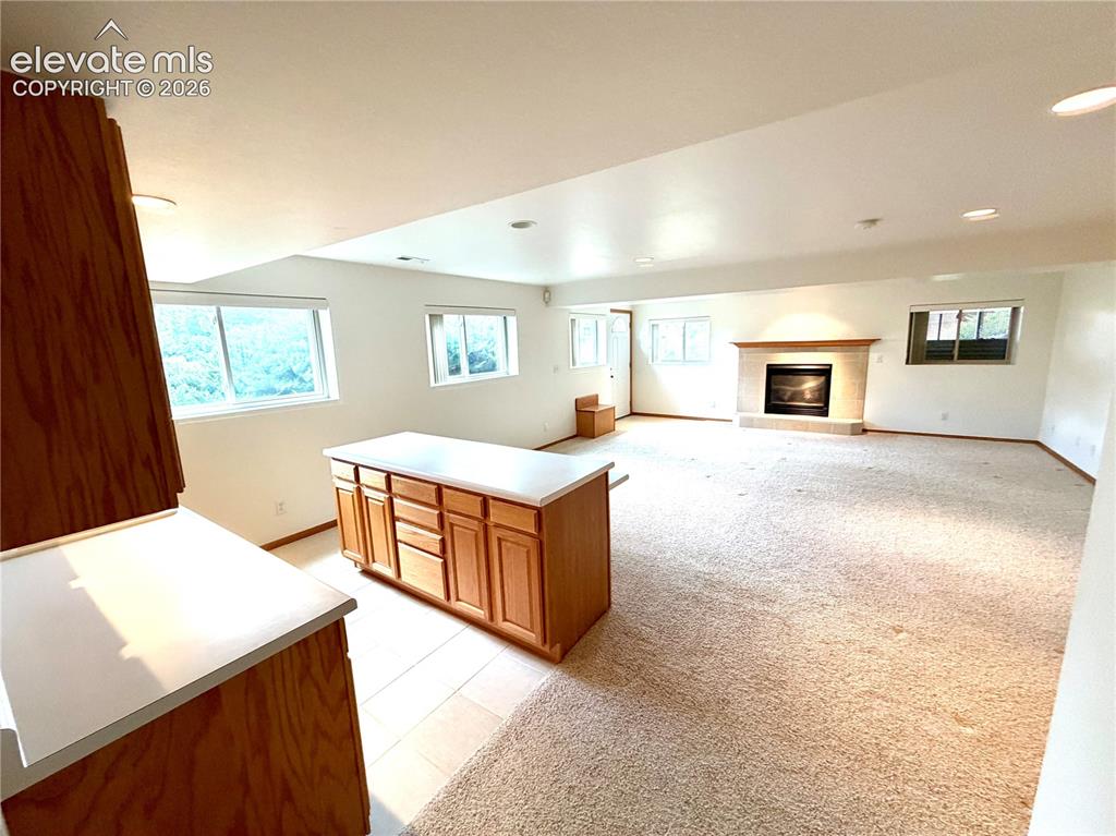 Image 43 of 50: Spacious open-concept room in the Basement featuring a functional kitchen i
