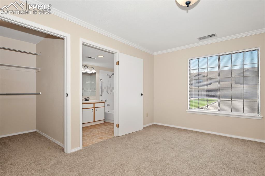 Image 14 of 27: Main bedroom with large walk in closet and attached bathroom