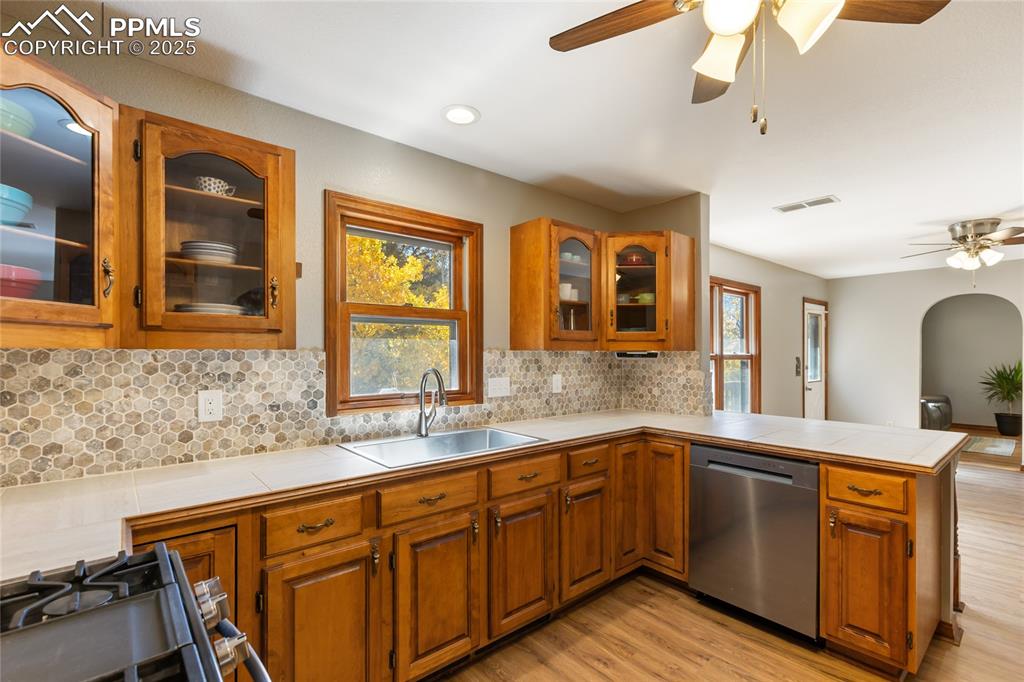 Image 15 of 50: Main level kitchen with newer stainless steel appliances, updated counterto