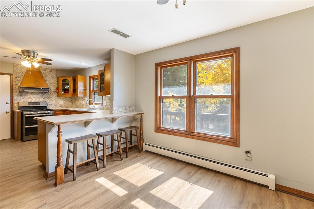 Image 17 of 50: Main level kitchen with breakfast bar, breakfast area, updated kitchen, new