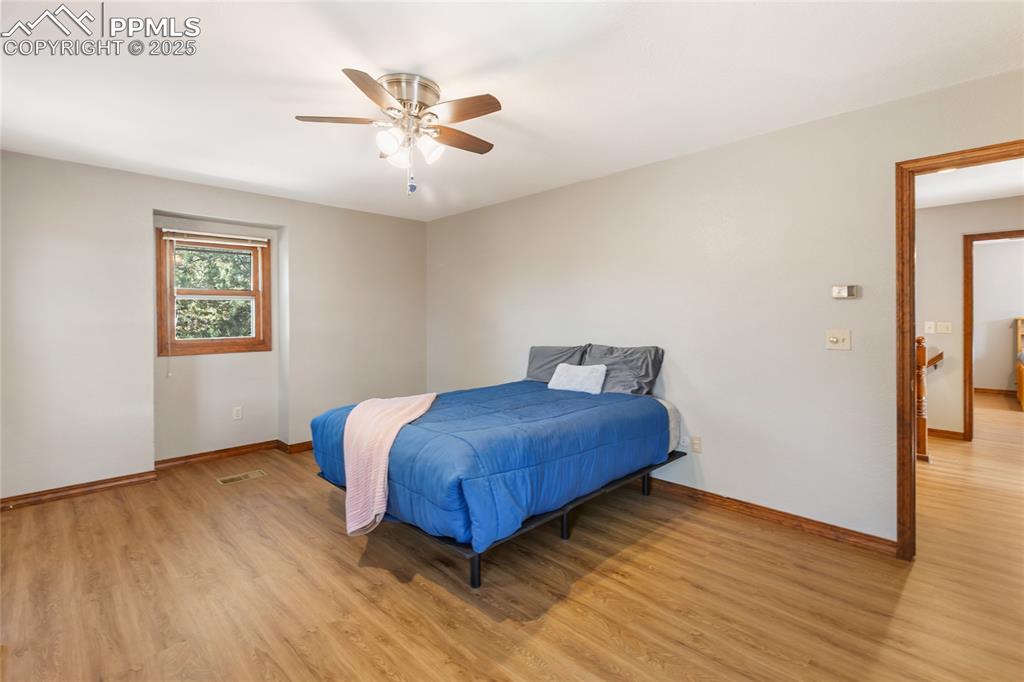 Image 24 of 50: Upper level bedroom with LVP flooring