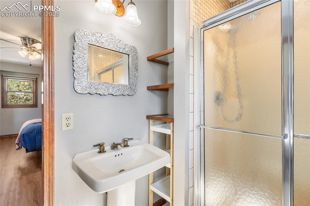 Image 25 of 50: Upper level ensuite with walk in shower, sink and walk in closet