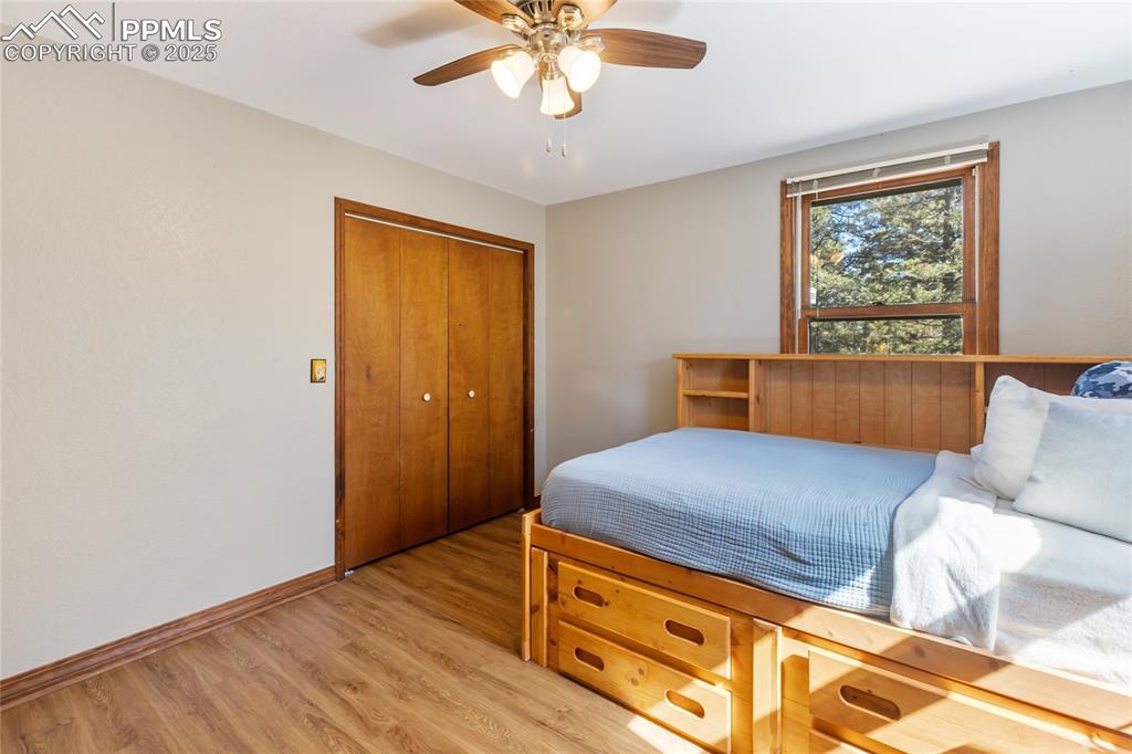 Image 27 of 50: Upper level bedroom #2 with LVP flooring