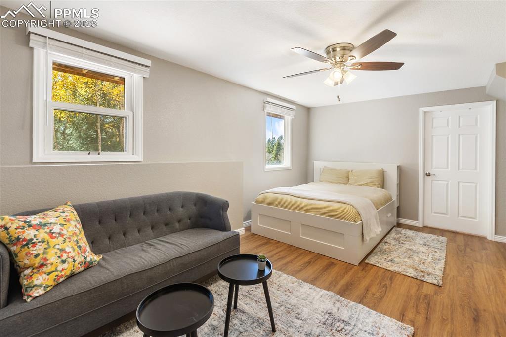 Image 34 of 50: Basement bedroom #4 with LVP flooring and sitting area