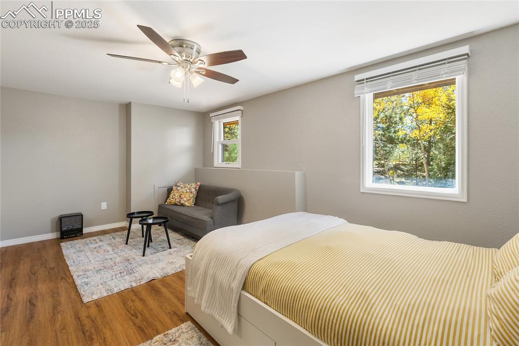 Image 35 of 50: Basement level bedroom #4 with LVP flooring and sitting area