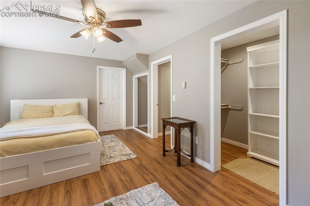 Image 36 of 50: Basement level bedroom with walk in closet and extra storage space under th