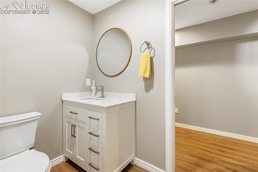 Image 38 of 50: Basement level bathroom separate toilet and sink 