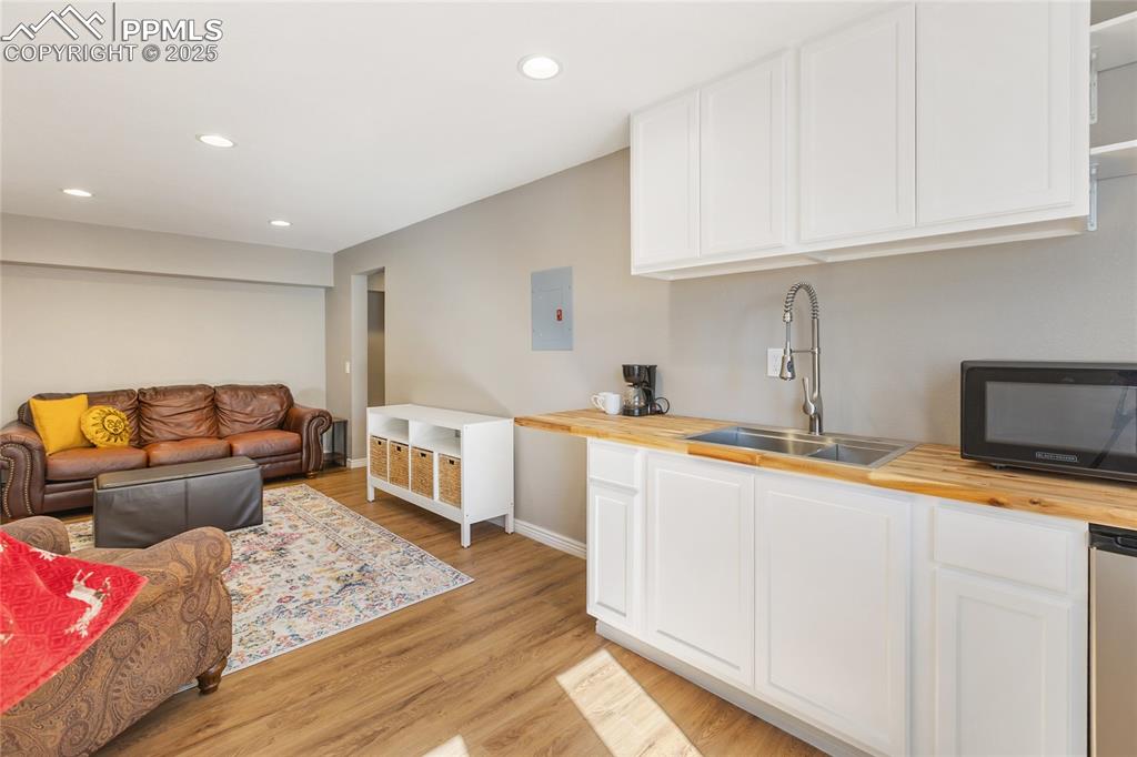 Image 41 of 50: Basement level family room with wet bar and walk out