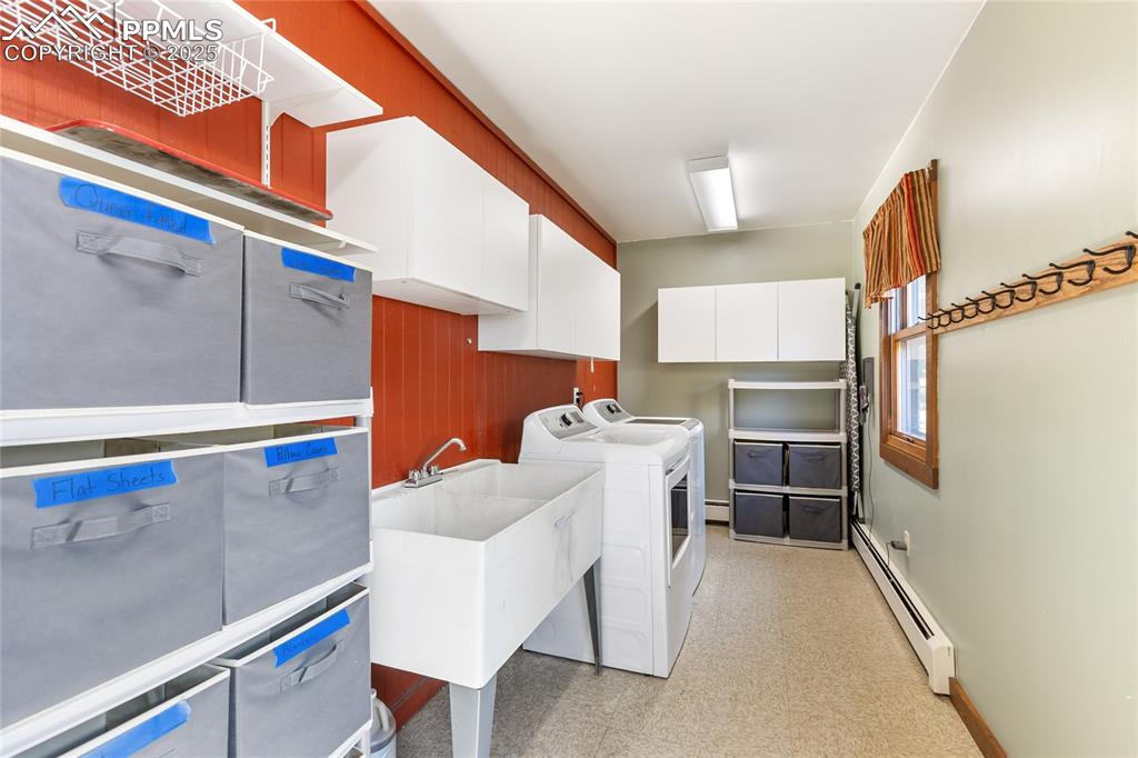 Image 43 of 50: Main level laundry with access to garage and walk out. Washer/dryer stay, u