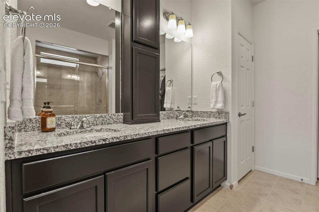 Image 17 of 34: Primary Bathroom with double vanities