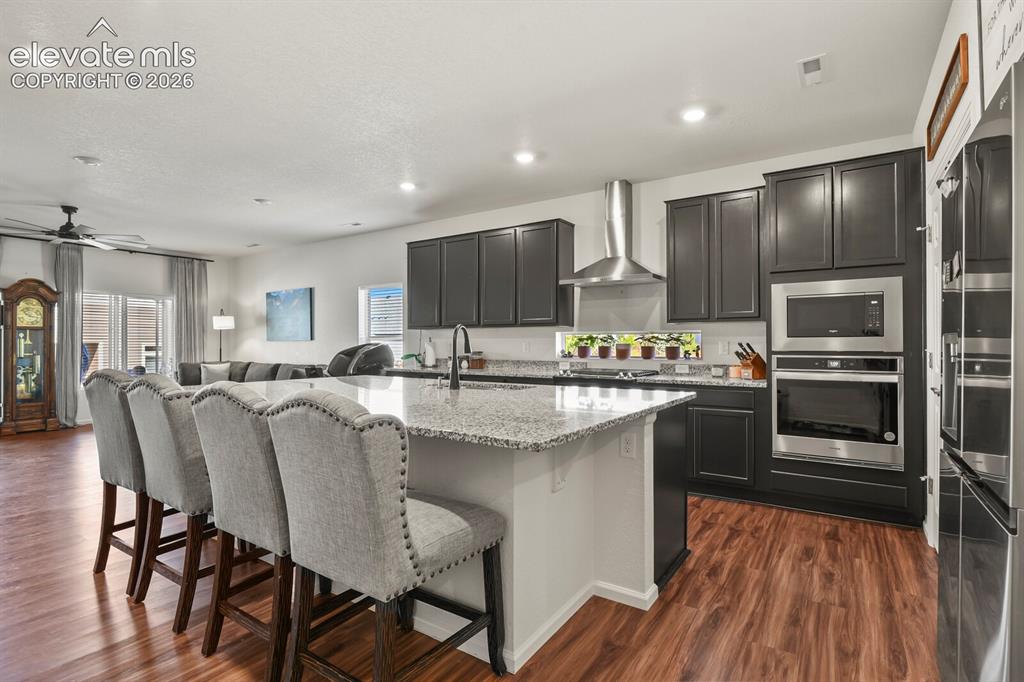 Image 2 of 34: Large kitchen island and stainless appliances