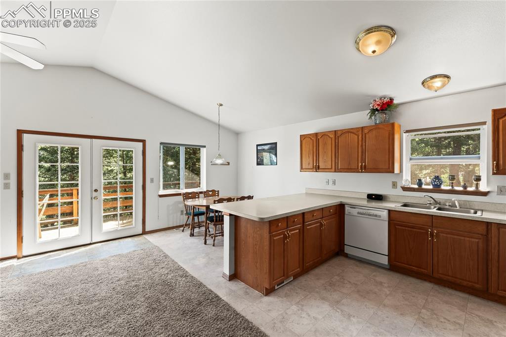Image 10 of 36: Kitchen and dining area with view of main entry in back of the house