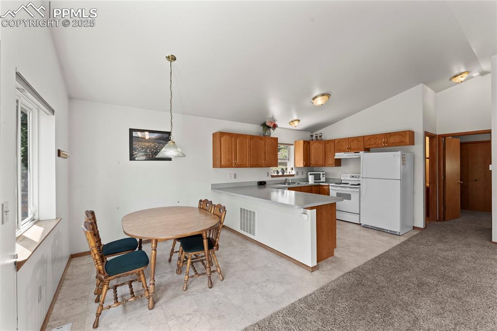 Image 13 of 36: Kitchen and dining area