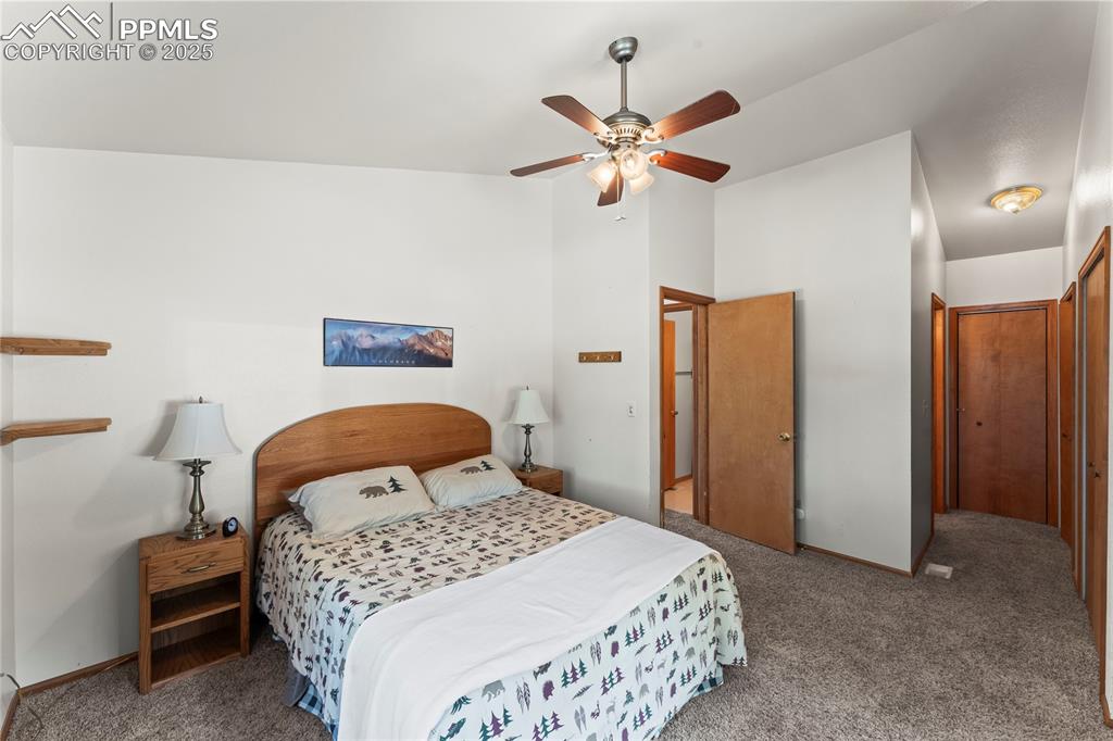 Image 18 of 36: Bedroom with closet space and access into primary bathroom