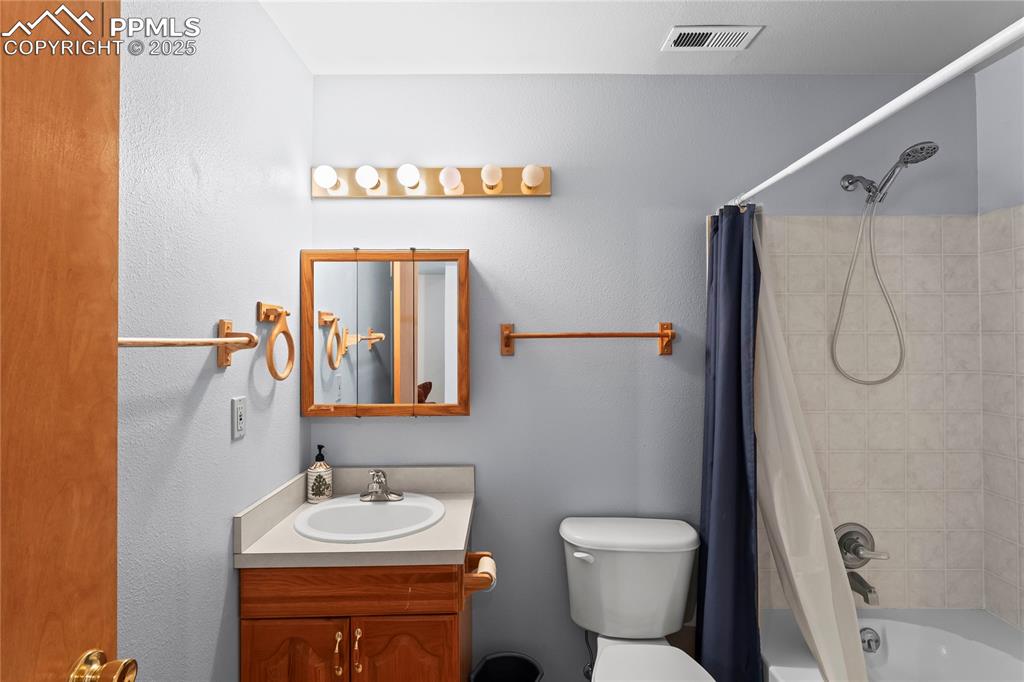 Image 27 of 36: Bathroom with vanity and shower / tub combo