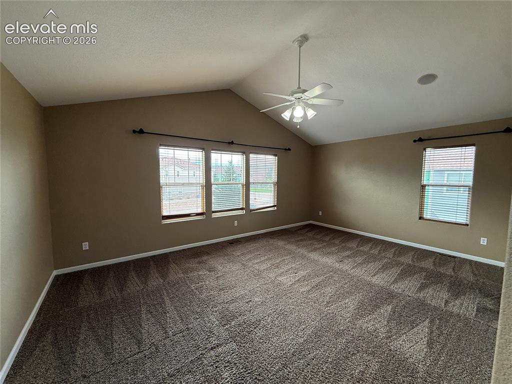 Image 12 of 28: Vaulted ceilings, neutral wall tones, multi-panel windows, ceiling fan with