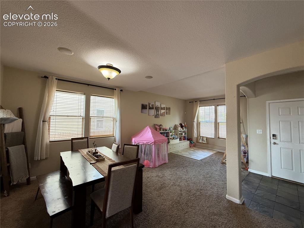 Image 4 of 27: Recessed lighting, ceiling-mounted fixture, multiple windows with blinds, a