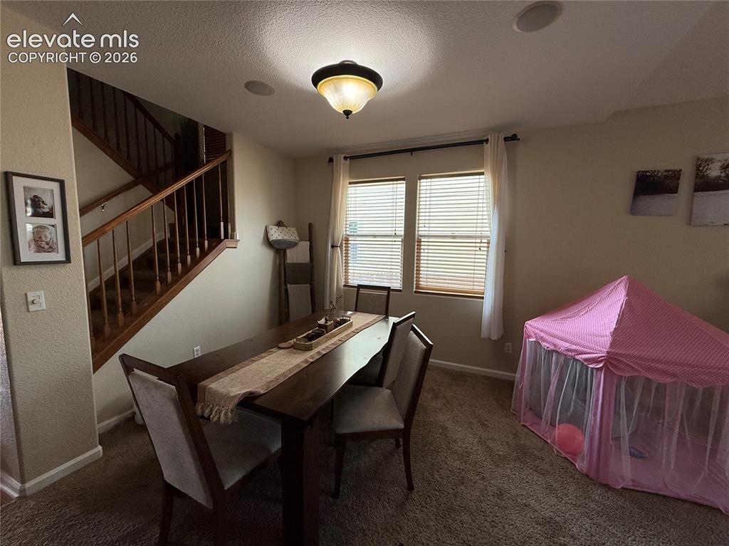 Image 5 of 27: Staircase with wood-finish handrail and balusters, flush-mount ceiling ligh