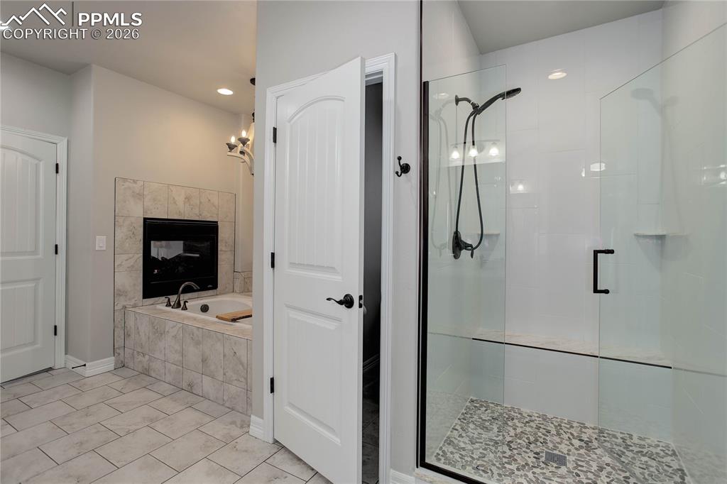 Image 13 of 38: Primary bath w/ soaking tub & standing shower