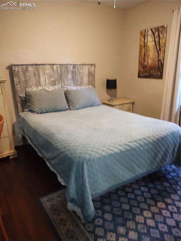 Image 11 of 30: Bedroom #2
 upper level featuring hardwood
 floors and ceiling fan