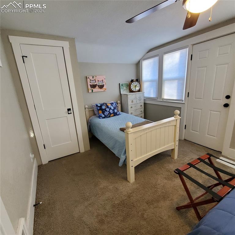 Image 12 of 30: Bedroom #3
 featuring vaulted ceiling, carpet floors, and a ceiling fan