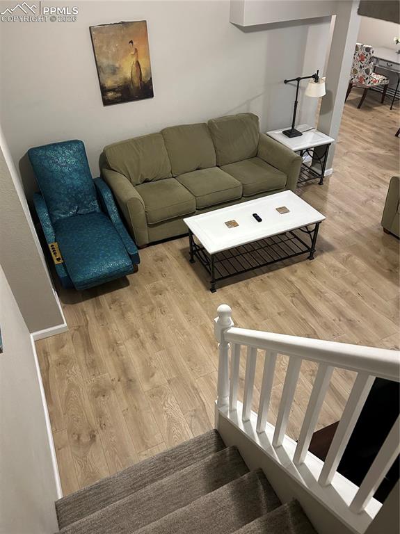 Image 13 of 30: Living area featuring stairs and light wood-type flooring