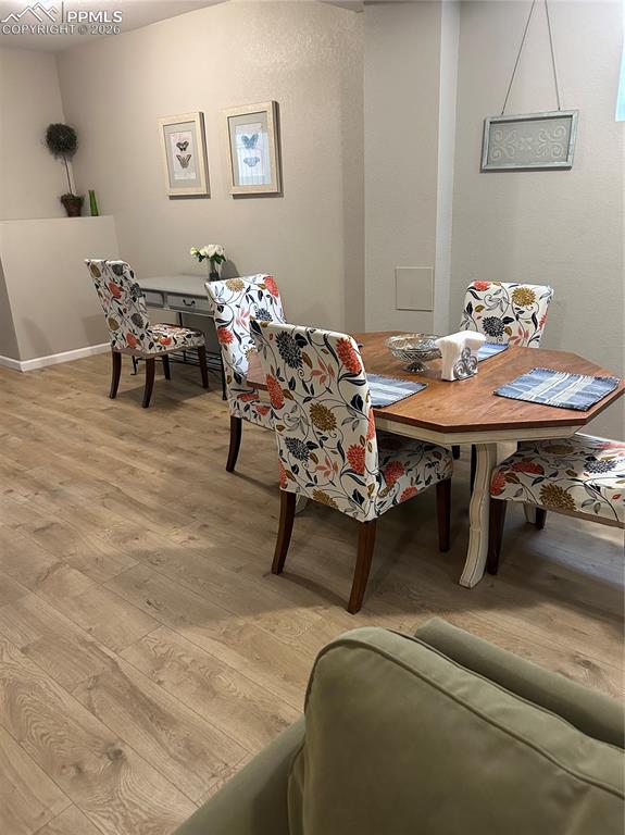 Image 23 of 30: Lower level dining
 room featuring light wood-style floors