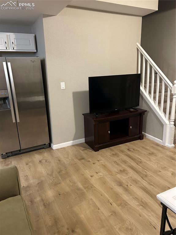 Image 25 of 30: lower level living room featuring  light wood-style flooring