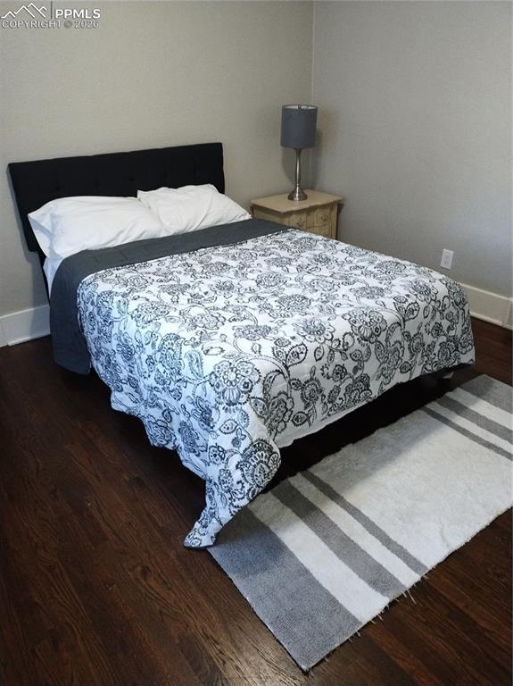 Image 29 of 30: Bedroom #1 upper level
 featuring dark wood finished floors and baseboards