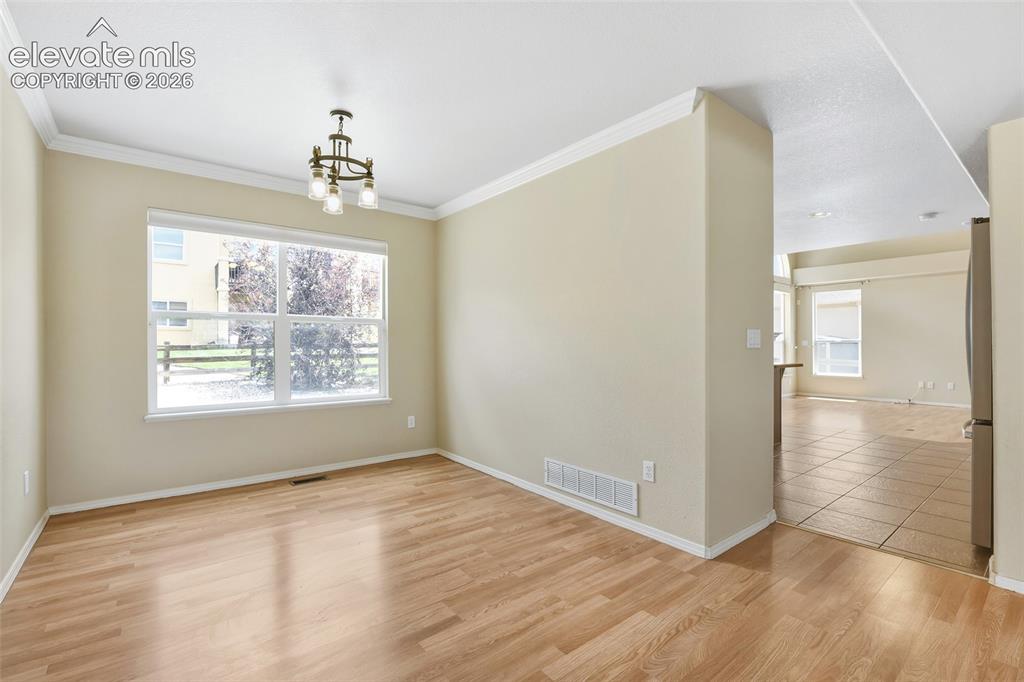 Image 10 of 34: Formal Dining Room with crown molding and access to kitchen