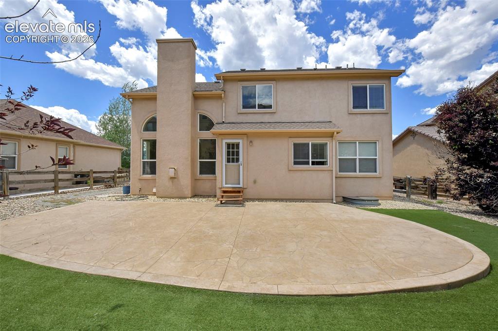 Image 31 of 34: Enormous stamped concrete back patio