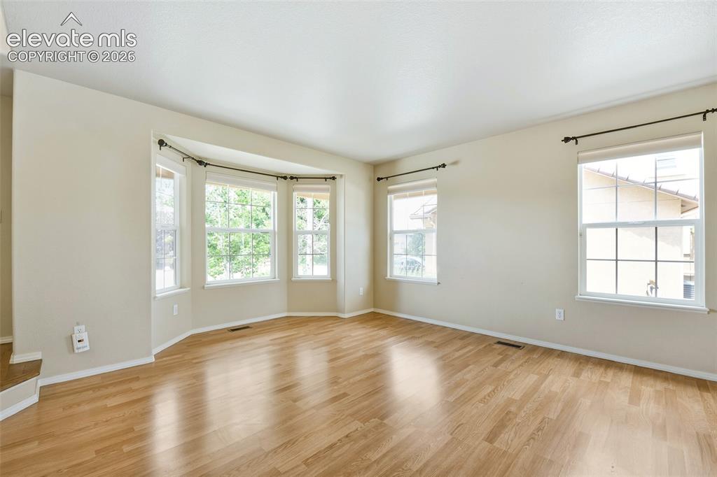 Image 5 of 34: Formal Living Room with bay window and views!