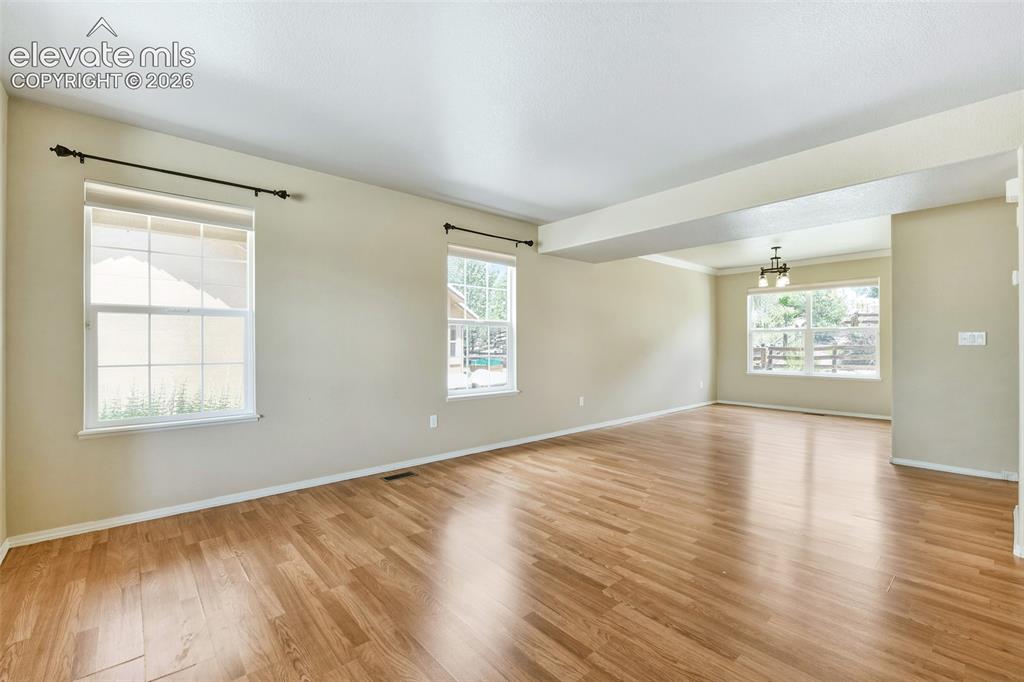 Image 9 of 34: Living Room opens to...