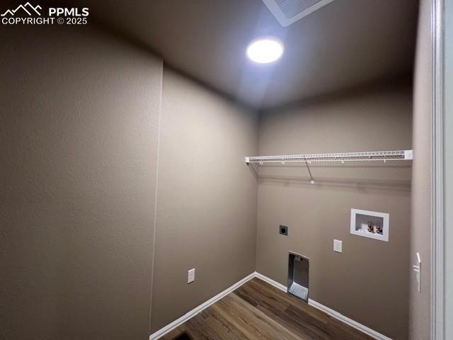 Image 14 of 22: Laundry area with washer hookup, electric dryer hookup, and wood-type floor