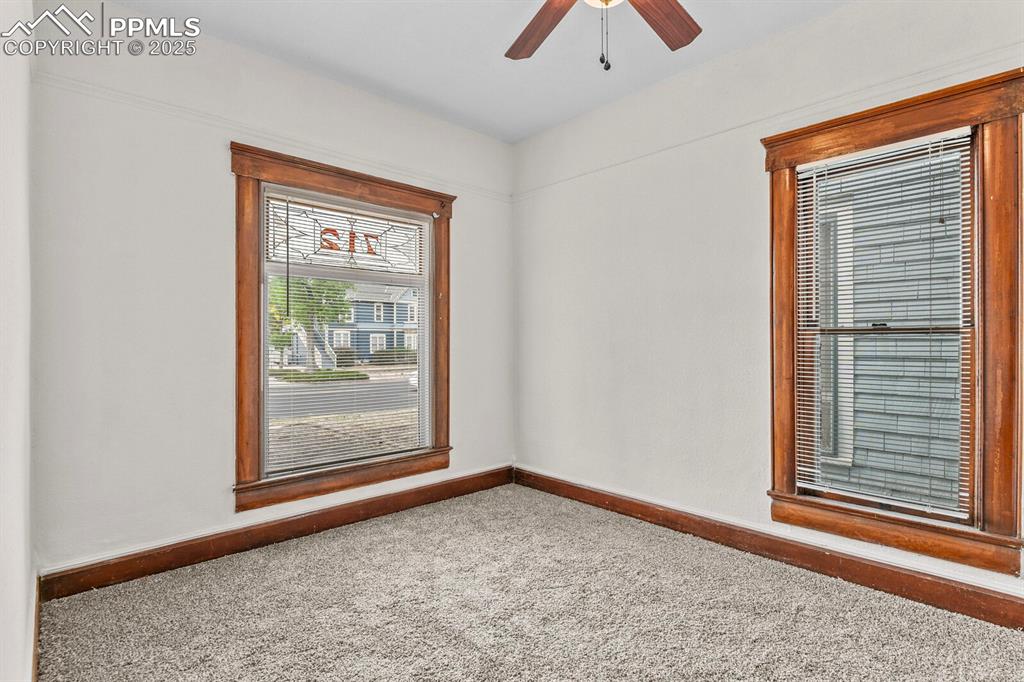 Image 11 of 30: Carpeted spare room featuring baseboards and ceiling fan